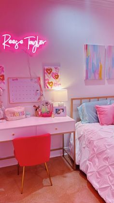 a room with a bed, desk and pink neon sign on the wall above it