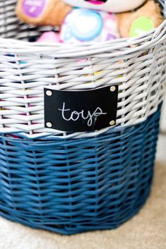 a teddy bear sitting in a basket with a toy tag on it's label