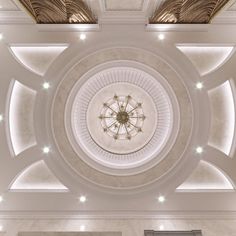 the ceiling in this room is decorated with white marble and lights on either side of it