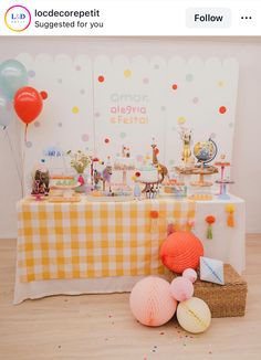 an image of a table with balloons and decorations for a baby's first birthday