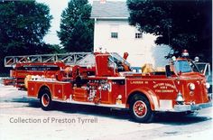 an old fire truck parked in front of a house