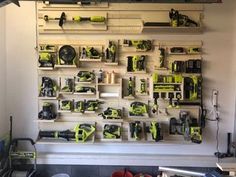 there are many tools on the wall in this garage, including drillers and screwdrivers