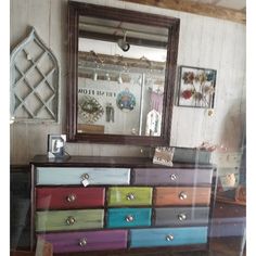 a multicolored dresser and mirror in a room