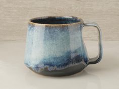 a blue and white mug sitting on top of a table