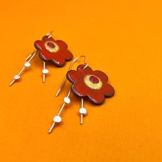 BIG BOLD FLAME ORANGE BLOSSOM earrings.... statement earrings for dressing up with just a bit of swing.  Wear what you love! Handmade enamel floral earrings perfect as a birthday or anniversay gift. handmade earrings... sawn, soldered, sanded,  and enameled... ..handfabricated and colored with ground frit these enamel earrings measure aproximately 2" long by 7/8".  * NOTE: The earring's enamel surface has tiny flecks of other colors embedded. The earrings are handmade and no two earrings are perfectly alike.  ♦ actually handmade ;) ♦ ready to ship ♦ measure approximately 2" long by 7/8" wide ♦ packaged in a gift box ...the perfect gift for someone special... or yourself.  #metalobjects - brandishing a torch and hammer for fun! Whimsical Spring Flower Earrings With Ear Wire, Red Flower Shaped Earrings For Spring, Orange Drop Earrings For Spring, Red Flower-shaped Earrings For Spring, Red Drop Earrings For Spring, Nickel-free Flower Drop Earrings For Summer, Red Flower Charm Jewelry For Spring, Red Spring Jewelry With Flower Charm, Spring Red Jewelry With Flower Charm