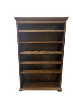 an old wooden bookcase with four shelves