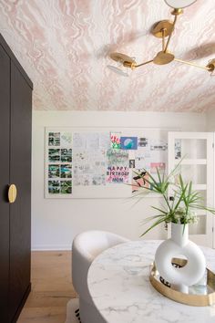 a dining room with marble table and chairs