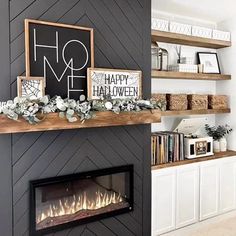 the fireplace is decorated with white flowers and greenery, along with bookshelves