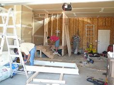 two men working on the framing of a house