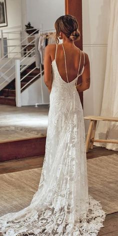 a woman in a wedding dress looking at her reflection