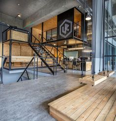 the inside of an office building with wooden floors and metal railings on each floor