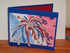 a card with red, white and blue fireworks on it