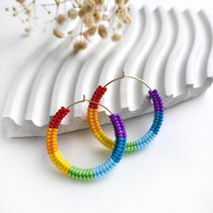 Brighten Your Style with These Colorful Beaded Hoop Earrings! For the Bold and Fashion-Forward These vibrant hoop earrings are perfect for anyone who loves to make a statement with their accessories. Whether you're dressing up for a special occasion or adding a pop of color to your everyday look, these earrings are designed for those who embrace their unique style. Product Features Design: Hoop earrings wrapped with high-quality, vibrant multicolored beads. Color: Gold-tone hoops with bright, saturated pink and green beads. Size: 4 cm in diameter (approximately 1.57 inches). Weight: Light and comfortable, weighing just 5 grams for the pair. Style: Bright, cheerful, youthful, and minimalist. All earrings hooks are nickel and lead free! Why You'll Love Them These earrings are more than just Trendy Rainbow Hoop Jewelry, Multicolor Small Hoop Earrings For Everyday, Handmade Minimalist Rainbow Jewelry, Everyday Multicolor Small Hoop Earrings, Trendy Handmade Hoop Beaded Earrings, Trendy Small Hoop Rainbow Jewelry, Handmade Rainbow Earrings For Everyday, Handmade Rainbow Earrings For Everyday Wear, Colorful Trendy Hoop Earrings As Gift