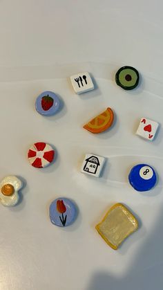 several different types of magnets on a white surface with one being an egg and the other is a house