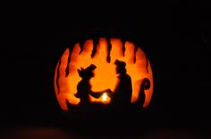 a carved pumpkin with an image of two people holding hands