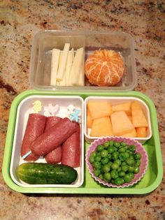 a green tray filled with different types of food