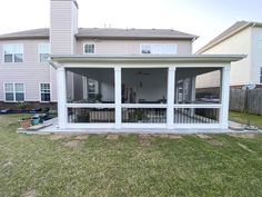 a screened in porch with sliding glass doors on the front and back side of it