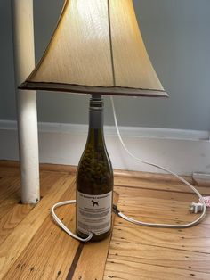 a lamp that is sitting on top of a wooden floor next to a light bulb