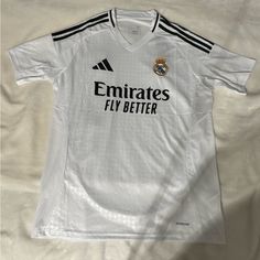 the jersey worn by real madrid's team is displayed on a white bed sheet