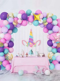 a unicorn themed birthday party with balloons and confetti