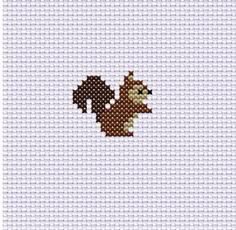 a cross stitch pattern with a squirrel on it's back and an orange tail