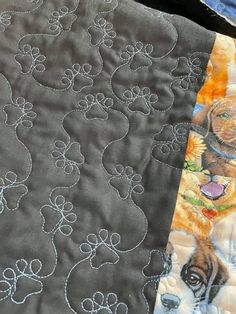 two quilts with dogs on them and one has a dog's paw print