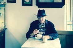 a man sitting at a table with a coffee cup