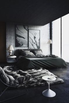 a bedroom with black and white decor in the corner, along with a large painting on the wall