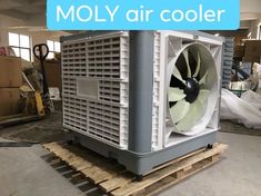 an air cooler sitting on top of pallets in a warehouse