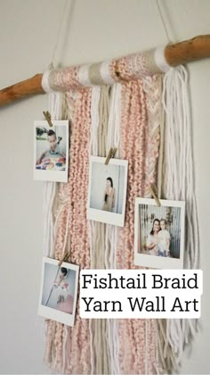 several pictures hanging on a wall with some wood stick and string attached to it,