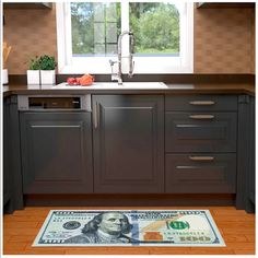 a kitchen with a dollar bill rug on the floor