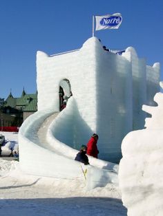 two people are sitting in front of an ice castle