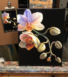 a painting of flowers on a black background with other art work in the back ground