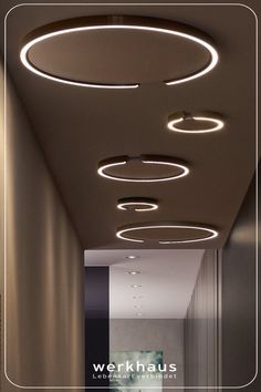 an image of a hallway that has lights on the ceiling and in the middle of it