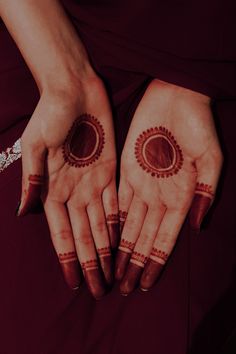 two hands with hendi designs on them, one is holding the other's hand