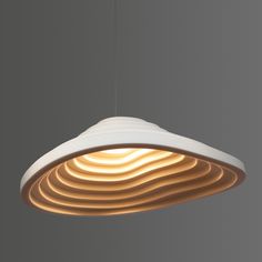 a white light hanging from a ceiling with wavy lines on the bottom and top of it