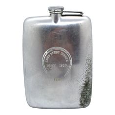 a silver flask with the name and date engraved on it's front side