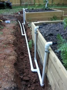 an image of a garden that is being worked on in the day time with pipes running through it