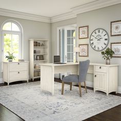 a room with a desk, chair, and clock on the wall in front of it