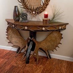 an antler's head is on top of a table in front of a mirror