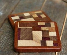 two wooden coasters sitting on top of a wooden table