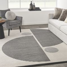 a living room with two chairs and a rug on the floor