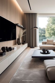 a living room with couches, tables and a large tv mounted on the wall