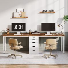 an office desk with two chairs and a computer monitor on top of it, in front of a white wall