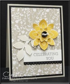 a close up of a card with a flower on the front and an inscription that reads celebrating you