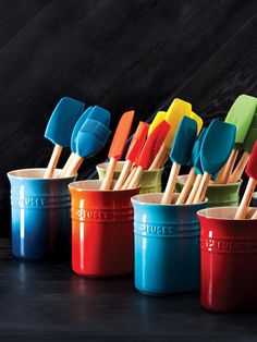 colorful plastic utensils are lined up in rows