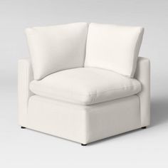 a white chair with two pillows on it