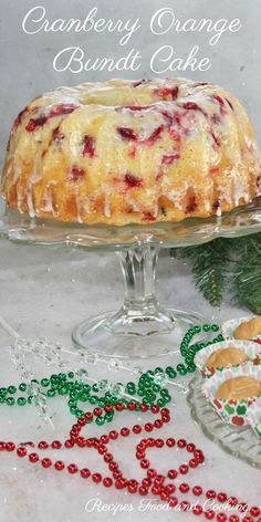 a cake with cranberry orange bundt cake in it on a glass platter