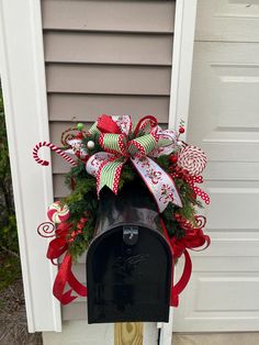 a mailbox decorated with christmas decorations and candy canes