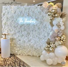 a white and gold wedding backdrop with flowers, balloons and the words the tenders on it